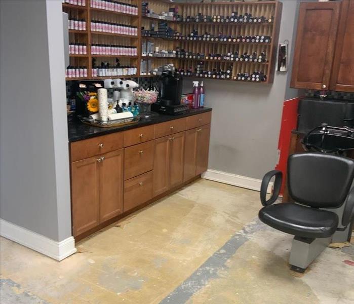 A salon washing station with removed flooring and clean, dry subfloors
