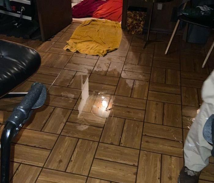 Tile floor with standing water and towels