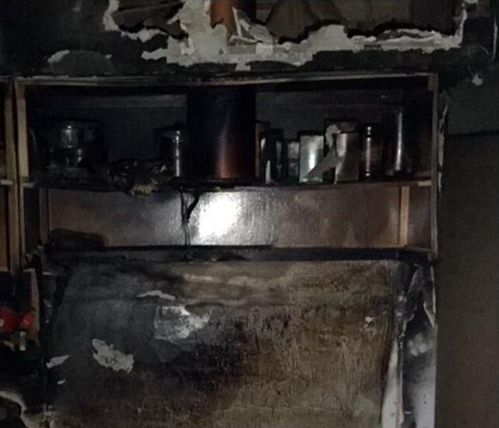 A kitchen with fire damage. 